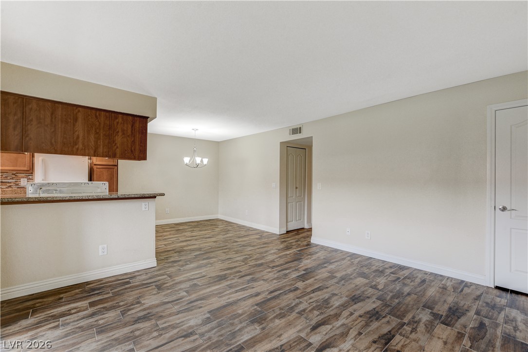 7200 West Pirates Cove Road, Unit 1026 Las Vegas, NV 89145 - Photo 7 of 35 This inviting space combines kitchen, dining, and living areas with durable, stylish flooring.
