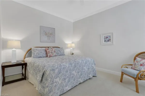 a bedroom with a bed and a lamp with window