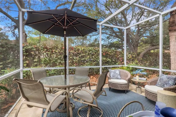 a patio with a patio table and chairs