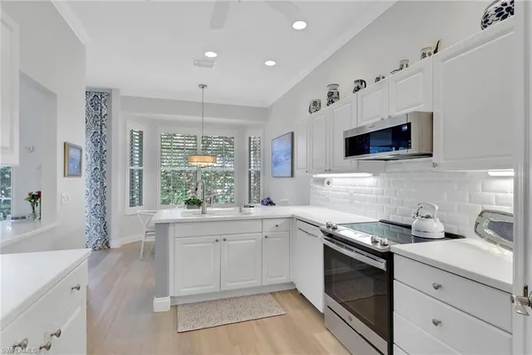 a kitchen with a sink stove and microwave