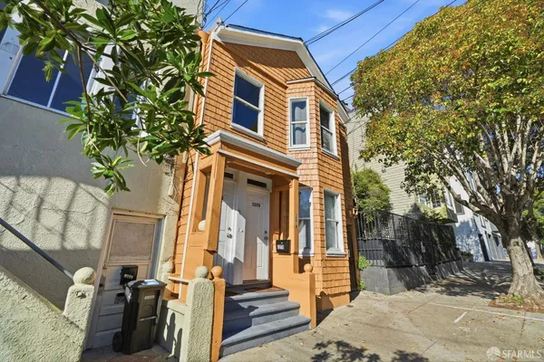 a view of a house with a tree