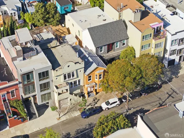 an aerial view of residential houses with outdoor space