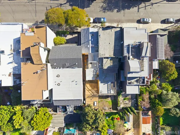 an aerial view of residential houses with outdoor space
