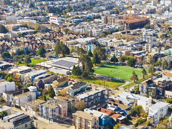 an aerial view of residential houses with outdoor space