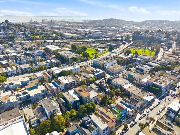 an aerial view of residential houses with outdoor space