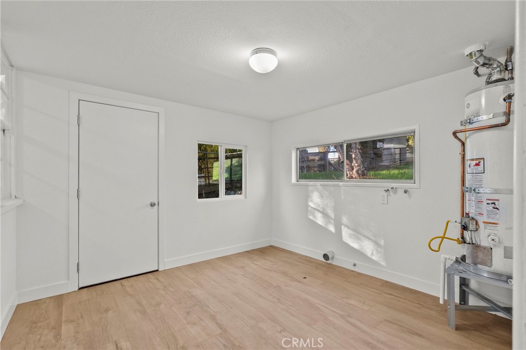 30541 Hasley Canyon Road Castaic, CA 91384 - Photo 16 of 31 a view of empty room with wooden floor and fan