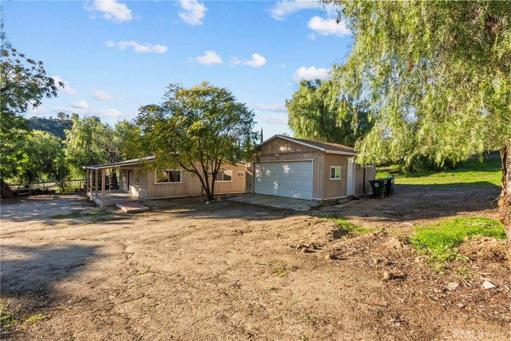 30541 Hasley Canyon Road Castaic, CA 91384 - Photo 24 of 31 a front view of a house with a yard and garage
