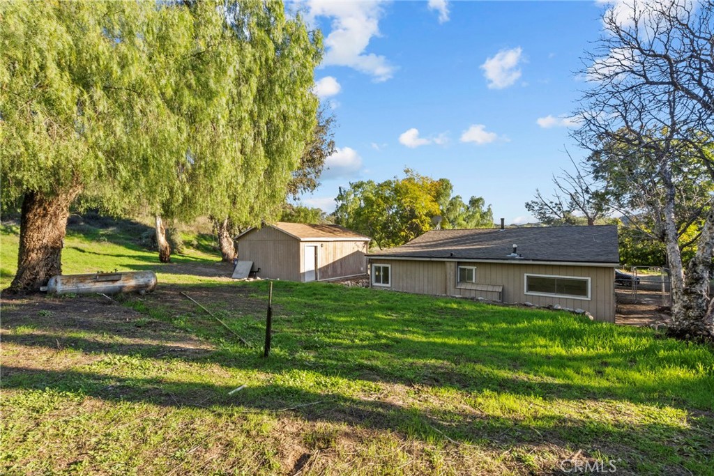 30541 Hasley Canyon Road Castaic, CA 91384 - Photo 26 of 31 a view of a house with a yard and a large tree
