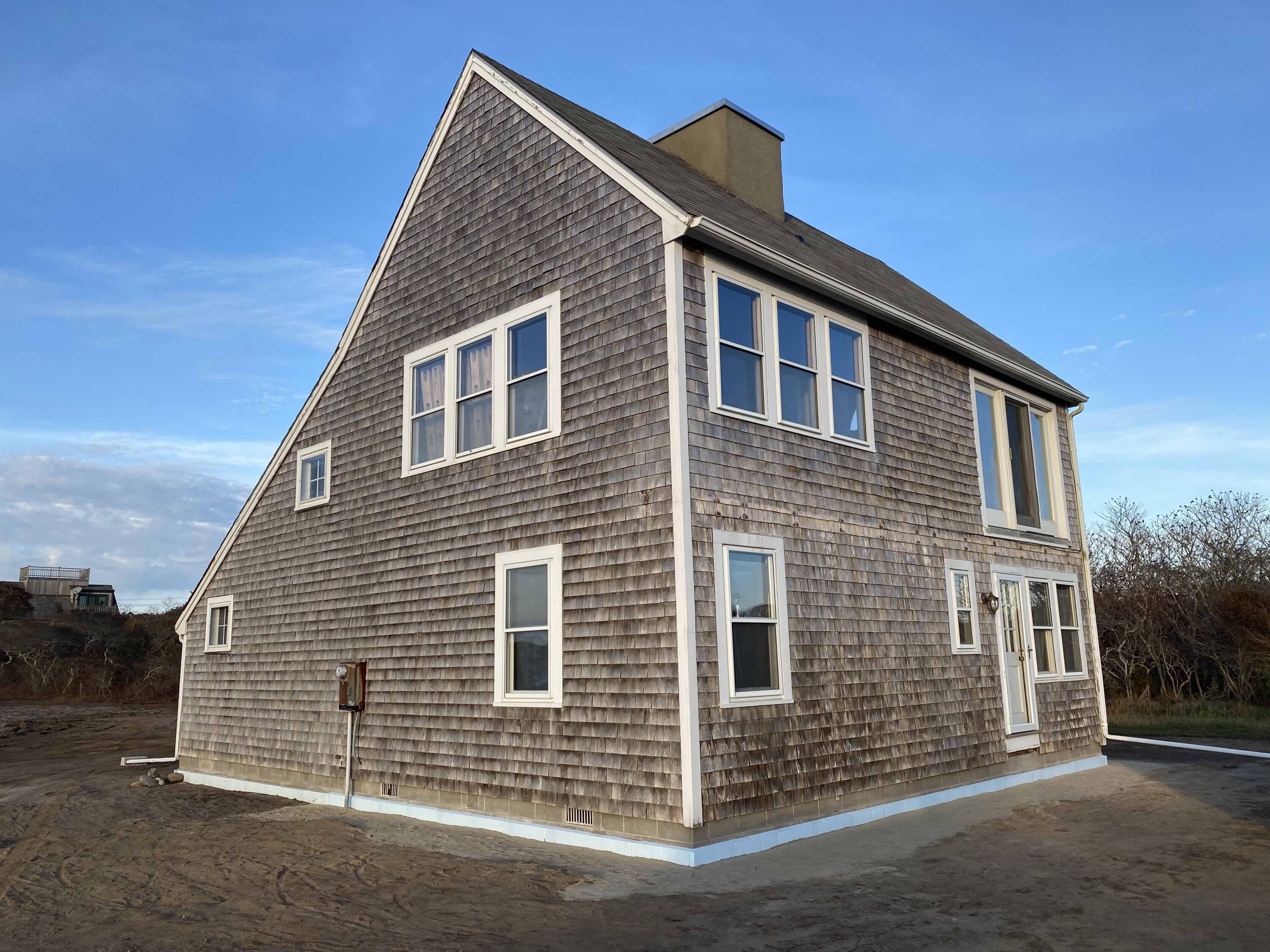 41 Wigwam Road Nantucket, MA 02554 - Photo 3 of 10 a front view of a house with a garage