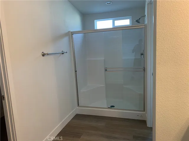 a bathroom with a glass shower door