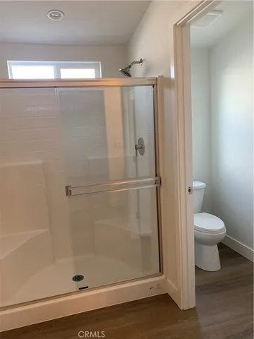 a bathroom with a shower and a toilet