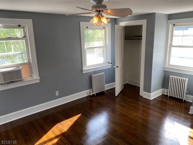 36 Elm Road Caldwell, NJ 07006 - Photo 14 of 28 an empty room with wooden floor chandelier and windows