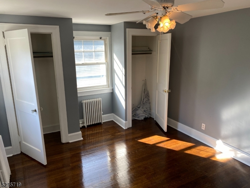 36 Elm Road Caldwell, NJ 07006 - Photo 15 of 28 an empty room with wooden floor and windows