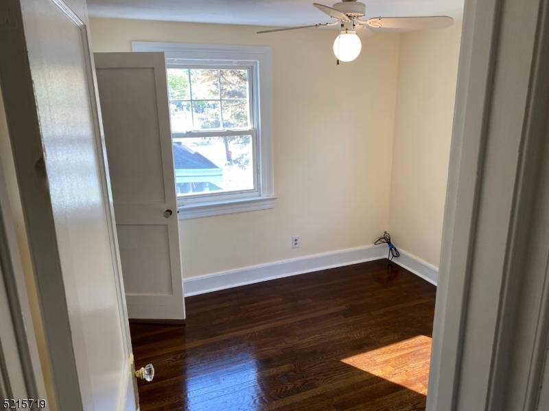 36 Elm Road Caldwell, NJ 07006 - Photo 16 of 28 a view of an empty room with wooden floor and a window