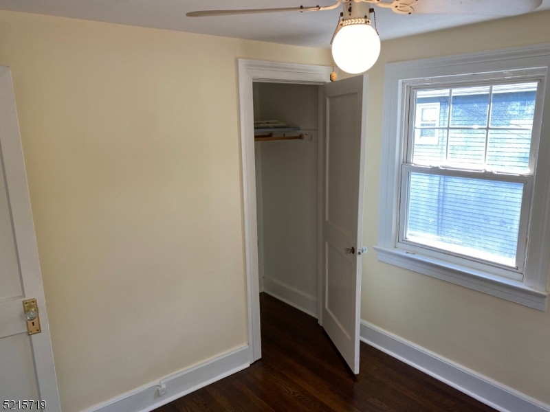 36 Elm Road Caldwell, NJ 07006 - Photo 17 of 28 an empty room with wooden floor and windows