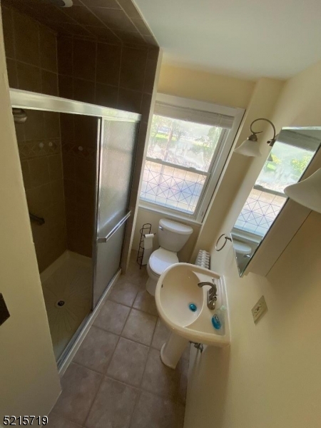36 Elm Road Caldwell, NJ 07006 - Photo 20 of 28 a bathroom with a granite countertop sink and a mirror