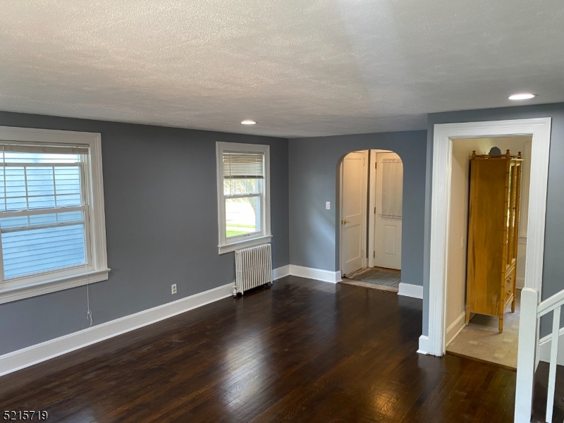 36 Elm Road Caldwell, NJ 07006 - Photo 6 of 28 an empty room with wooden floor and windows