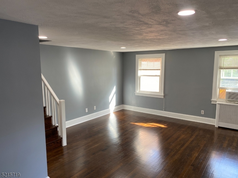 36 Elm Road Caldwell, NJ 07006 - Photo 7 of 28 an empty room with wooden floor and windows