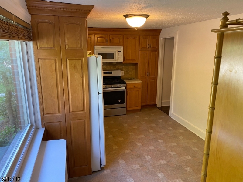 36 Elm Road Caldwell, NJ 07006 - Photo 8 of 28 a view of a kitchen with a refrigerator