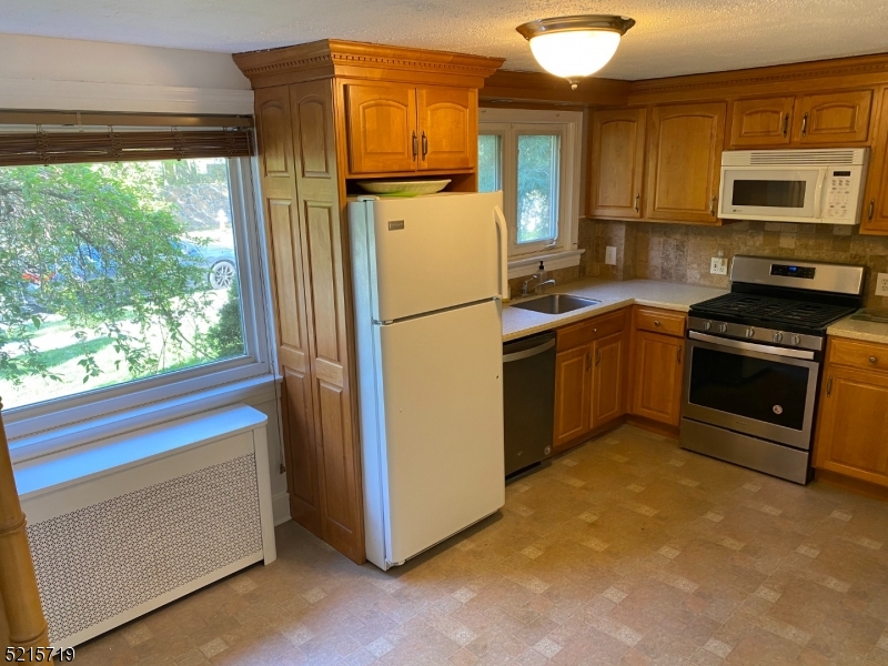 36 Elm Road Caldwell, NJ 07006 - Photo 9 of 28 a kitchen with stainless steel appliances granite countertop a refrigerator sink and stove