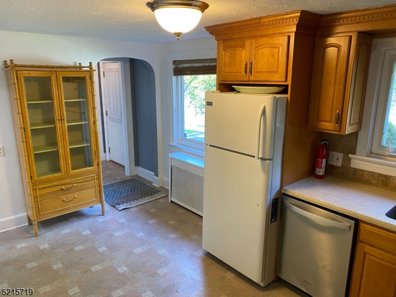 36 Elm Road Caldwell, NJ 07006 - Photo 10 of 28 a view of walk in closet with clothes and door