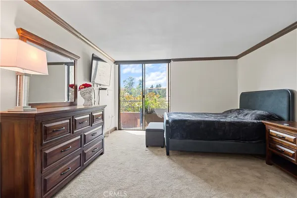 a living room with a bed furniture and a window