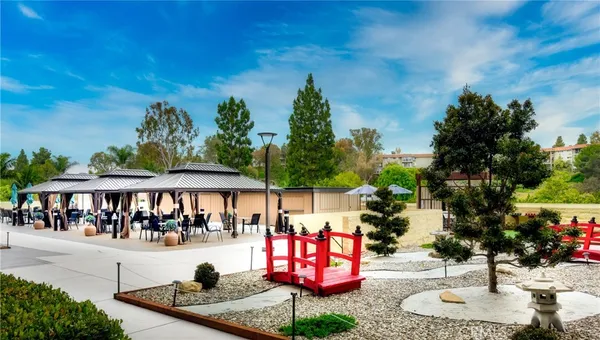 a swimming pool with outdoor seating and yard in the back