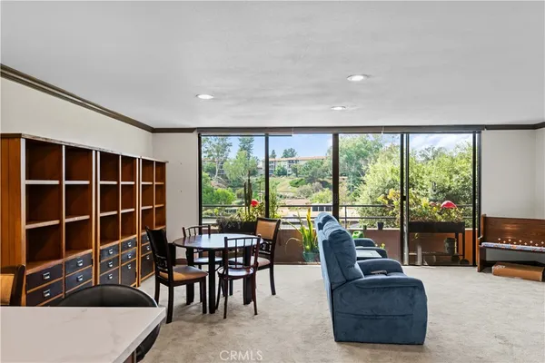 a living room with furniture and a floor to ceiling window
