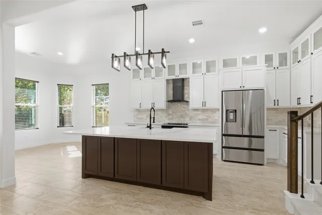 a kitchen with stainless steel appliances a sink stove and refrigerator