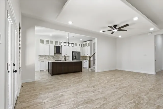 a large kitchen with a sink stainless steel appliances and cabinets