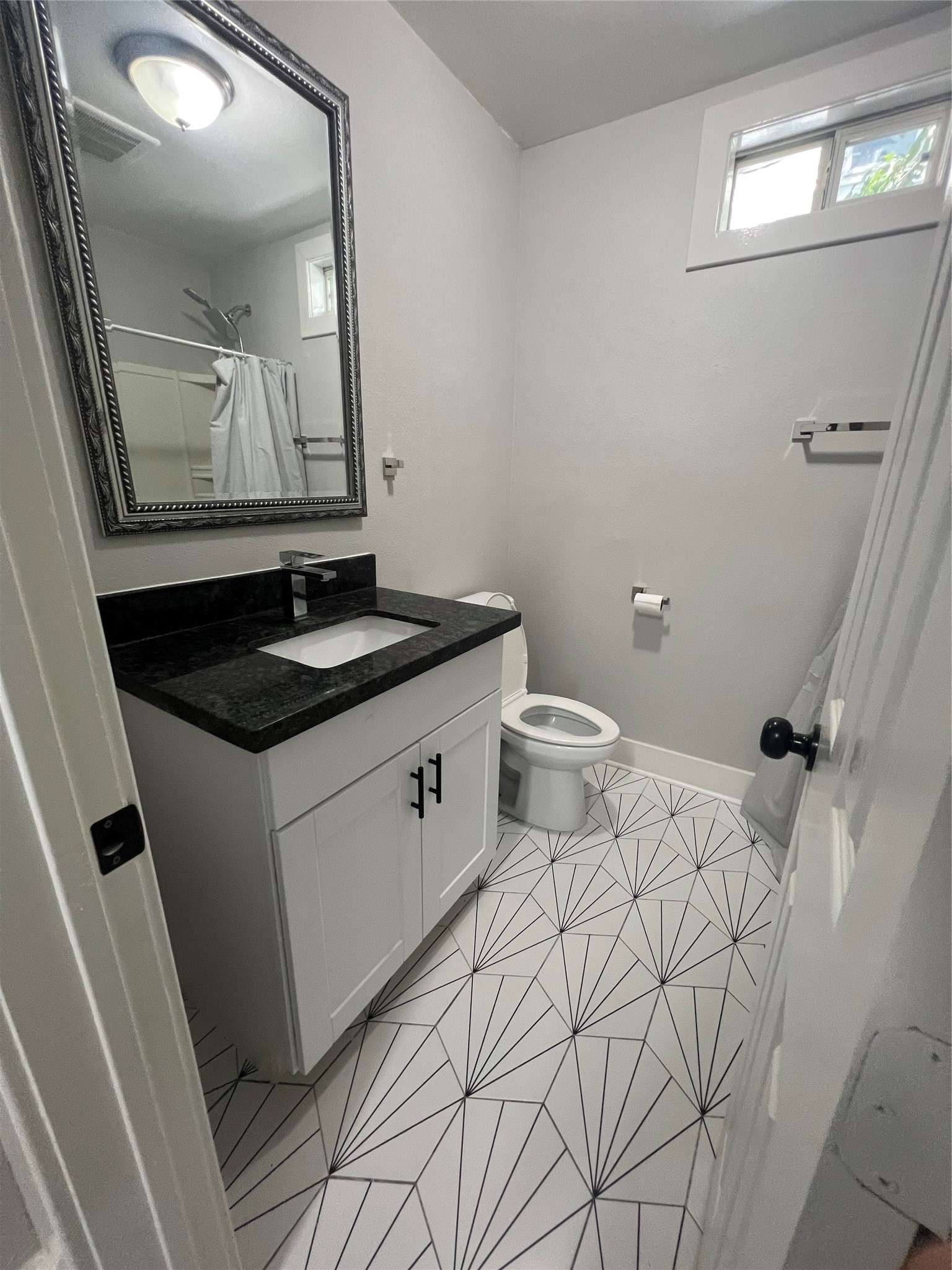 220 Redan Street, Unit A Houston, TX 77009 - Photo 14 of 22 a bathroom with a granite countertop sink and a mirror