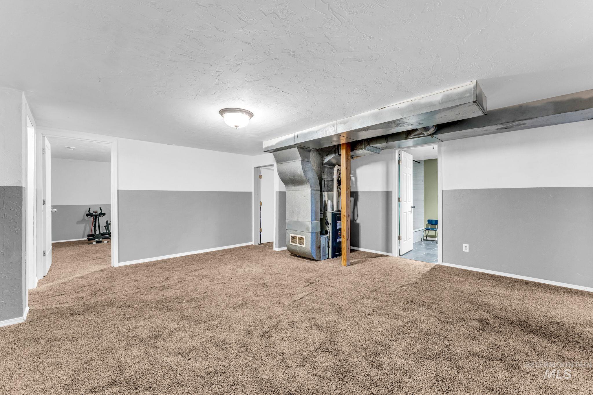 820 Meadows Drive Twin Falls, ID 83301 - Photo 21 of 38 Walk-in shower with a pebble floor and tiled walls featuring a mosaic accent strip