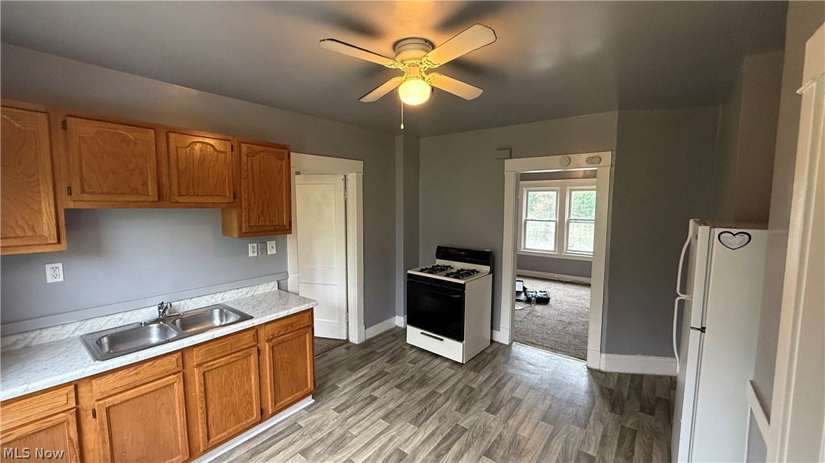 1187 Addison Road, Unit 4 Cleveland, OH 44103 - Photo 2 of 15 Kitchen featuring wood cabinetry, laminate countertops, a double basin stainless steel sink, and wood-finish flooring