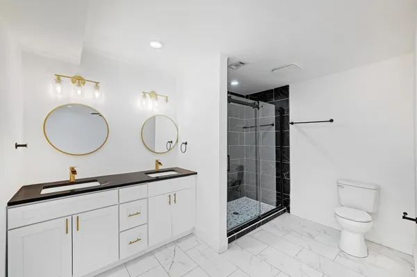 a bathroom with a toilet a sink and a mirror