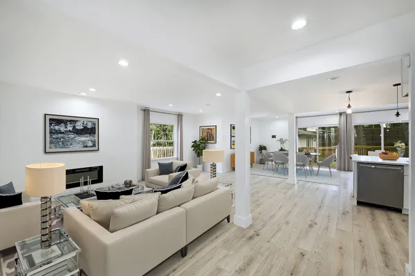 a living room with furniture and a wooden floor