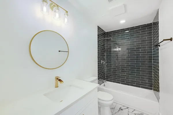 a bathroom with a sink toilet and shower