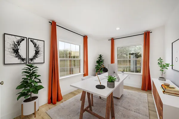 a living room with furniture potted plant and a large window