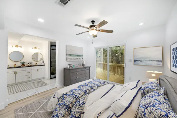a bedroom with a large bed and a chandelier