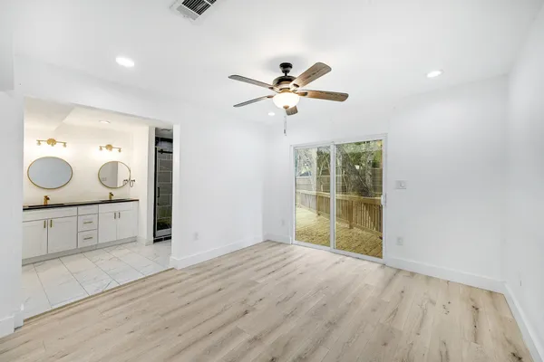 a view of a kitchen with a sink and a mirror