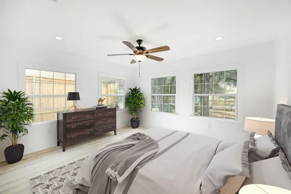 a bedroom with a bed and a large window
