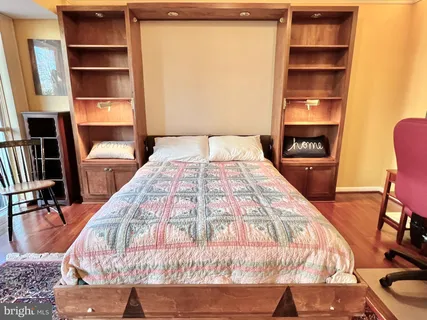 a large bed sitting in a bedroom next to a window