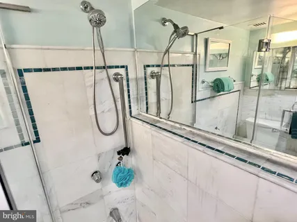 a bathroom with a shower and a sink
