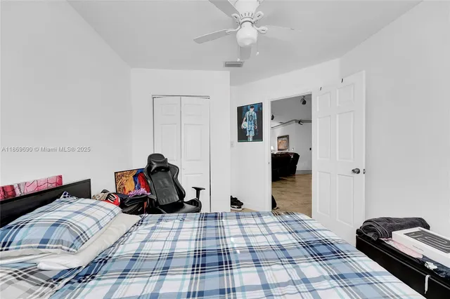 a bedroom that has a bed and a computer on a desk
