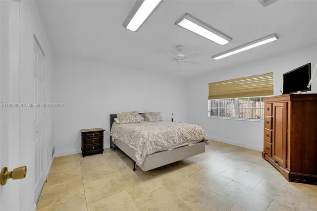 a bedroom with a bed and a flat tv screen