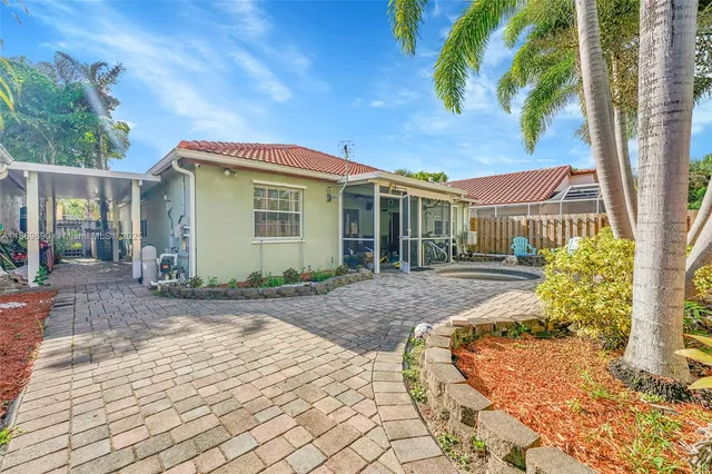 a view of backyard with outdoor seating and plants