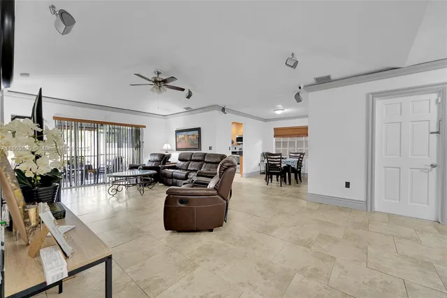 a living room with furniture and a ceiling fan