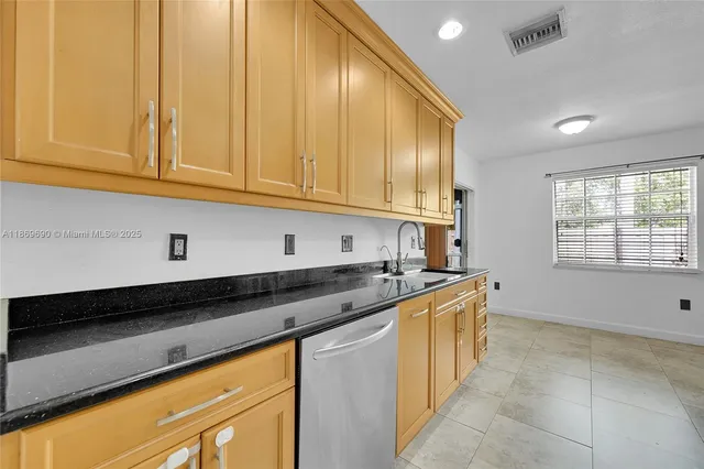 a kitchen with stainless steel appliances a refrigerator and a stove top oven