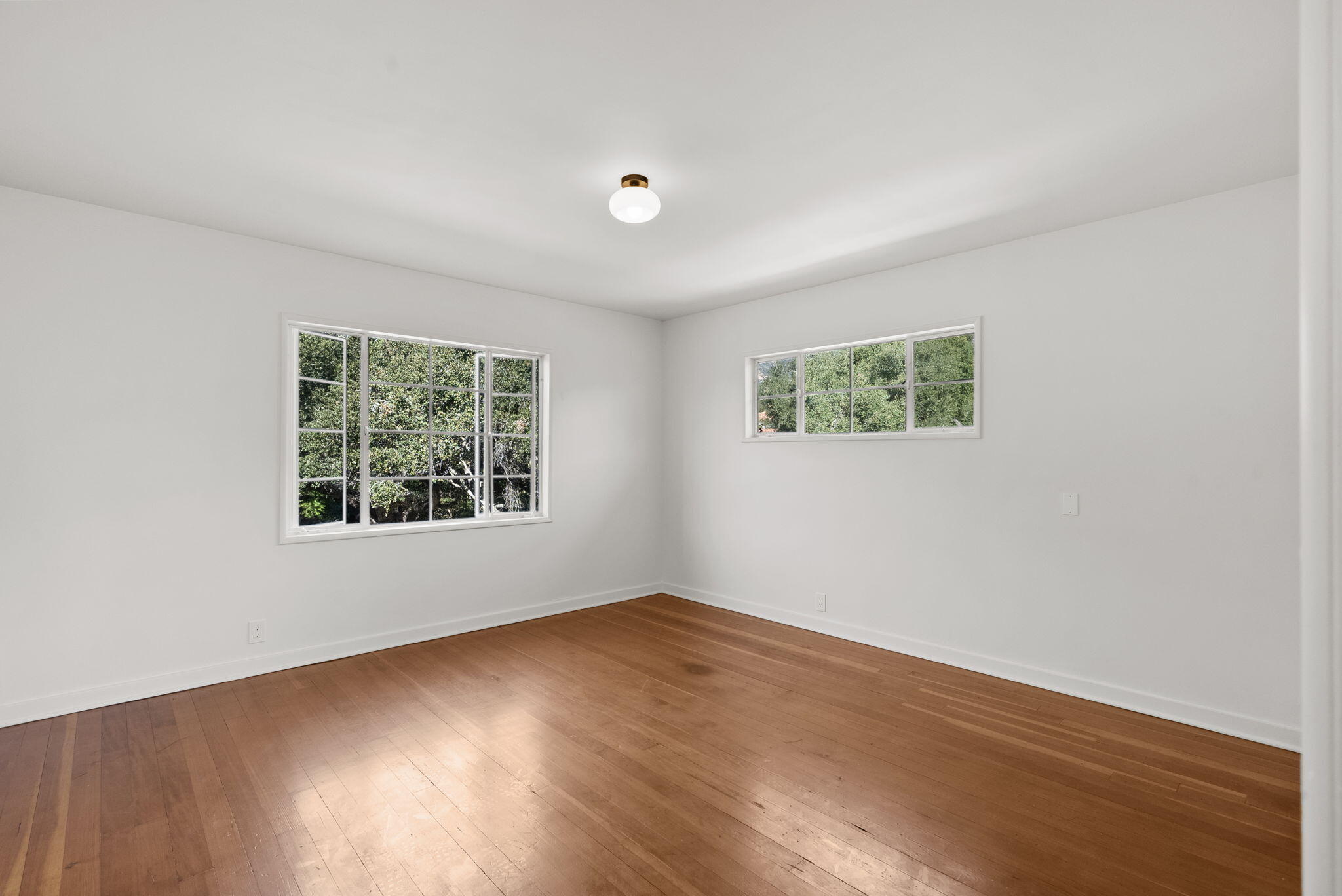633 Tabor Lane Montecito, CA 93108 - Photo 16 of 30 a view of an empty room with wooden floor and a window