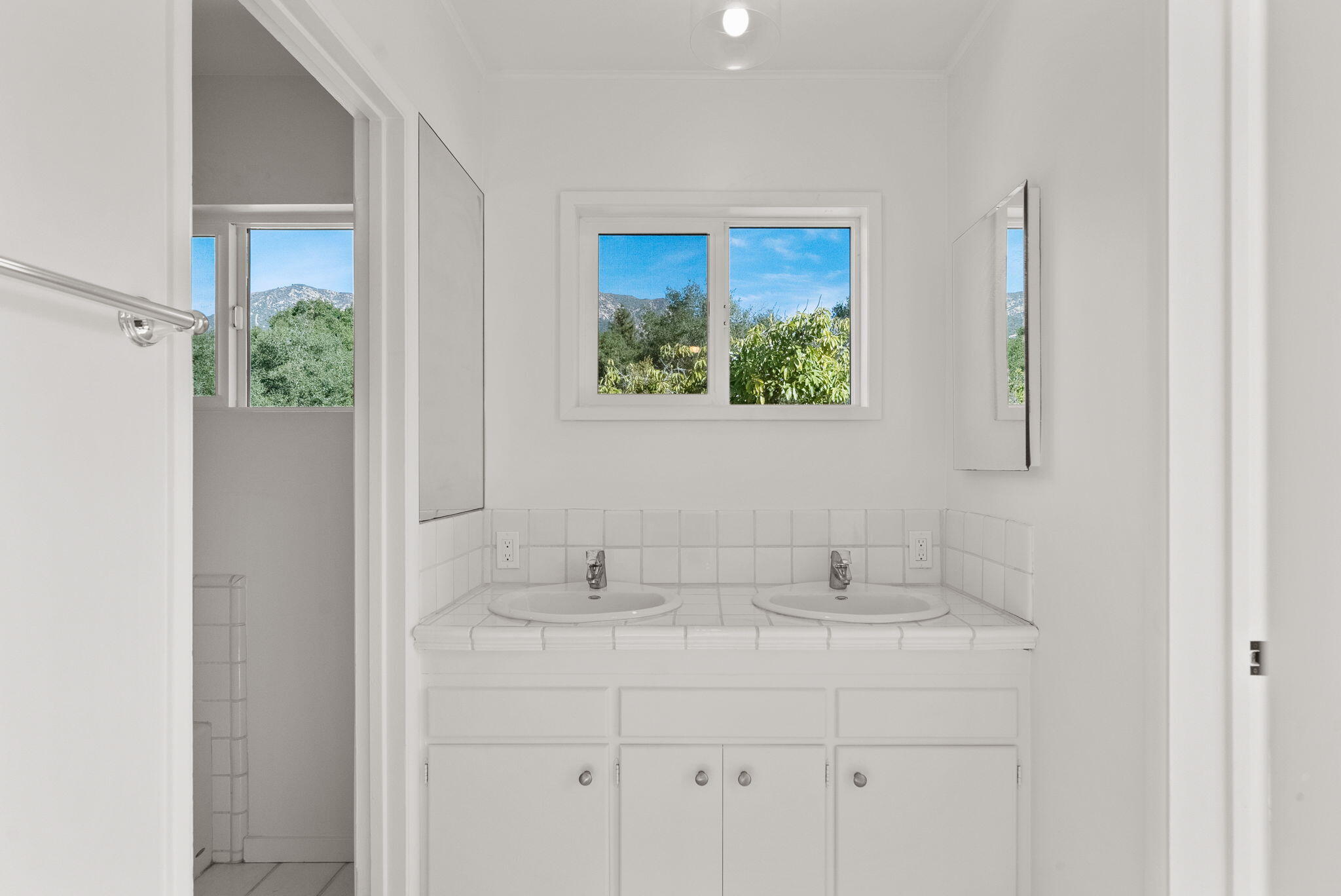 633 Tabor Lane Montecito, CA 93108 - Photo 17 of 30 a bathroom with a sink and a mirror
