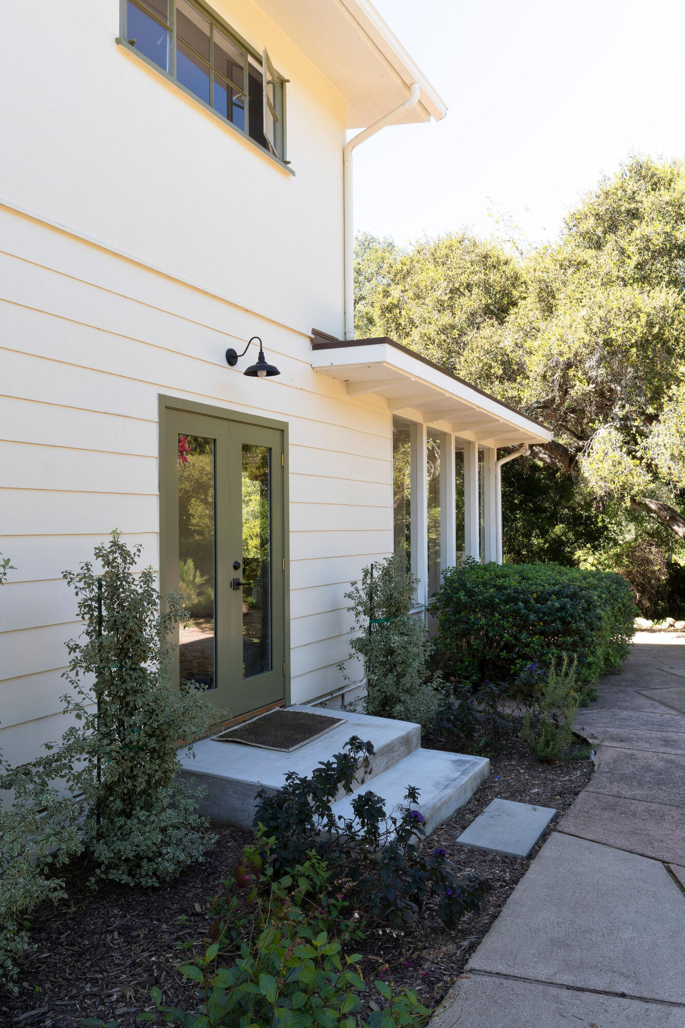 633 Tabor Lane Montecito, CA 93108 - Photo 3 of 30 a view of a house with potted plants and a bench